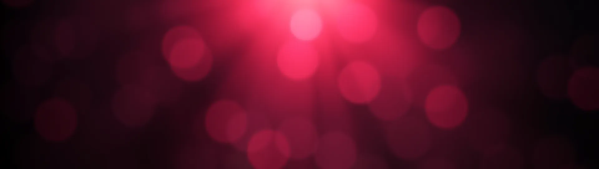 Αφηρημένη εικόνα με ρουμπινί φως και bokeh σε σκούρο φόντο